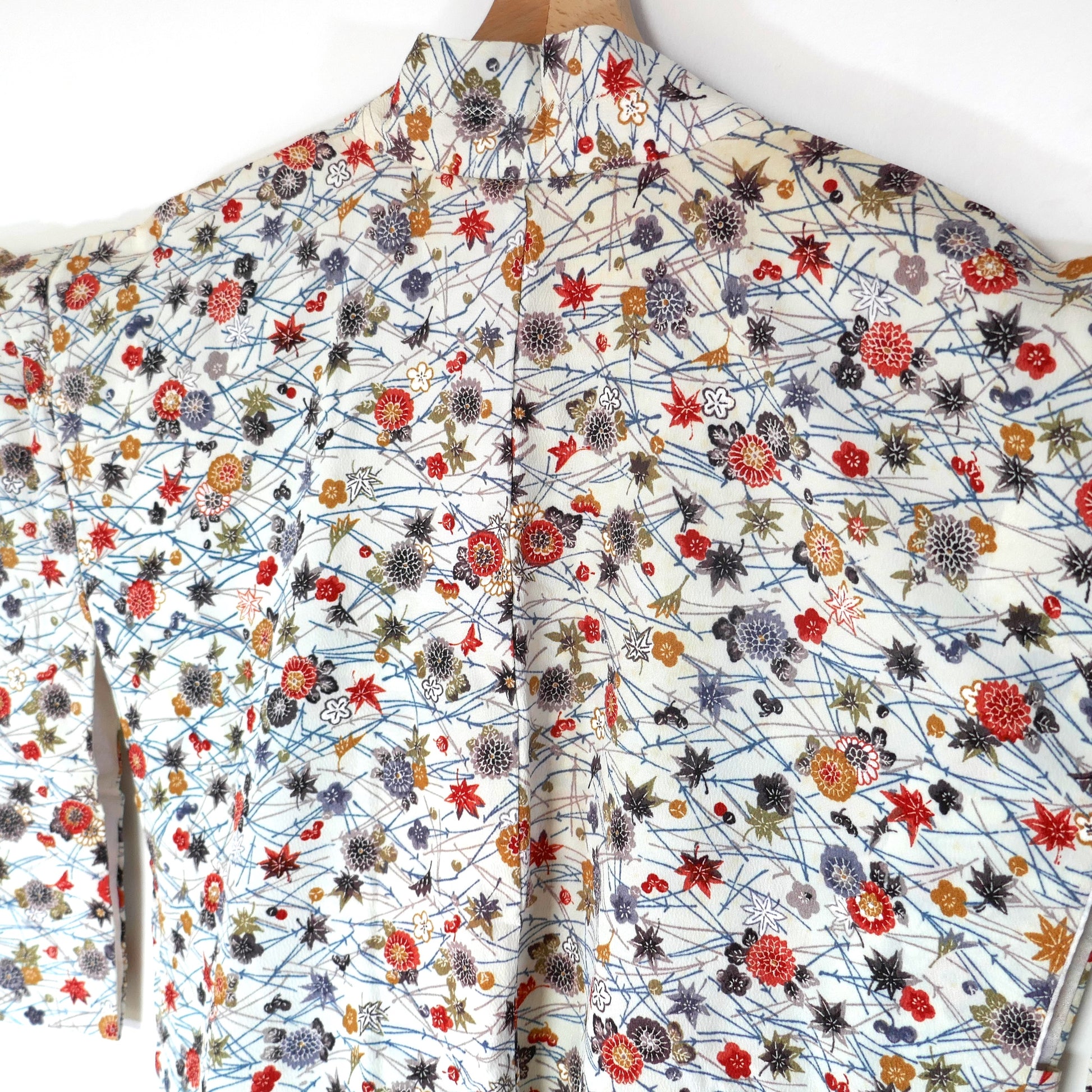 Détail du dos d’un haori en soie avec motifs de fleurs de chrysanthèmes 菊 et feuilles d’érable 紅葉.