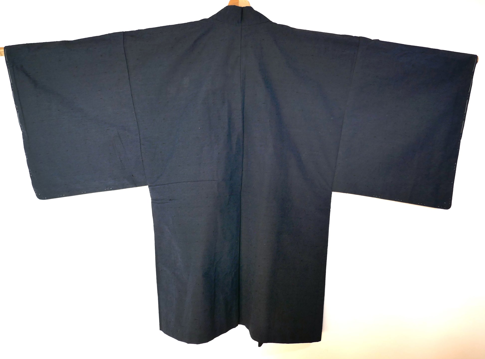 Vue de dos d’un haori japonais traditionnel pour homme en soie bleu foncé