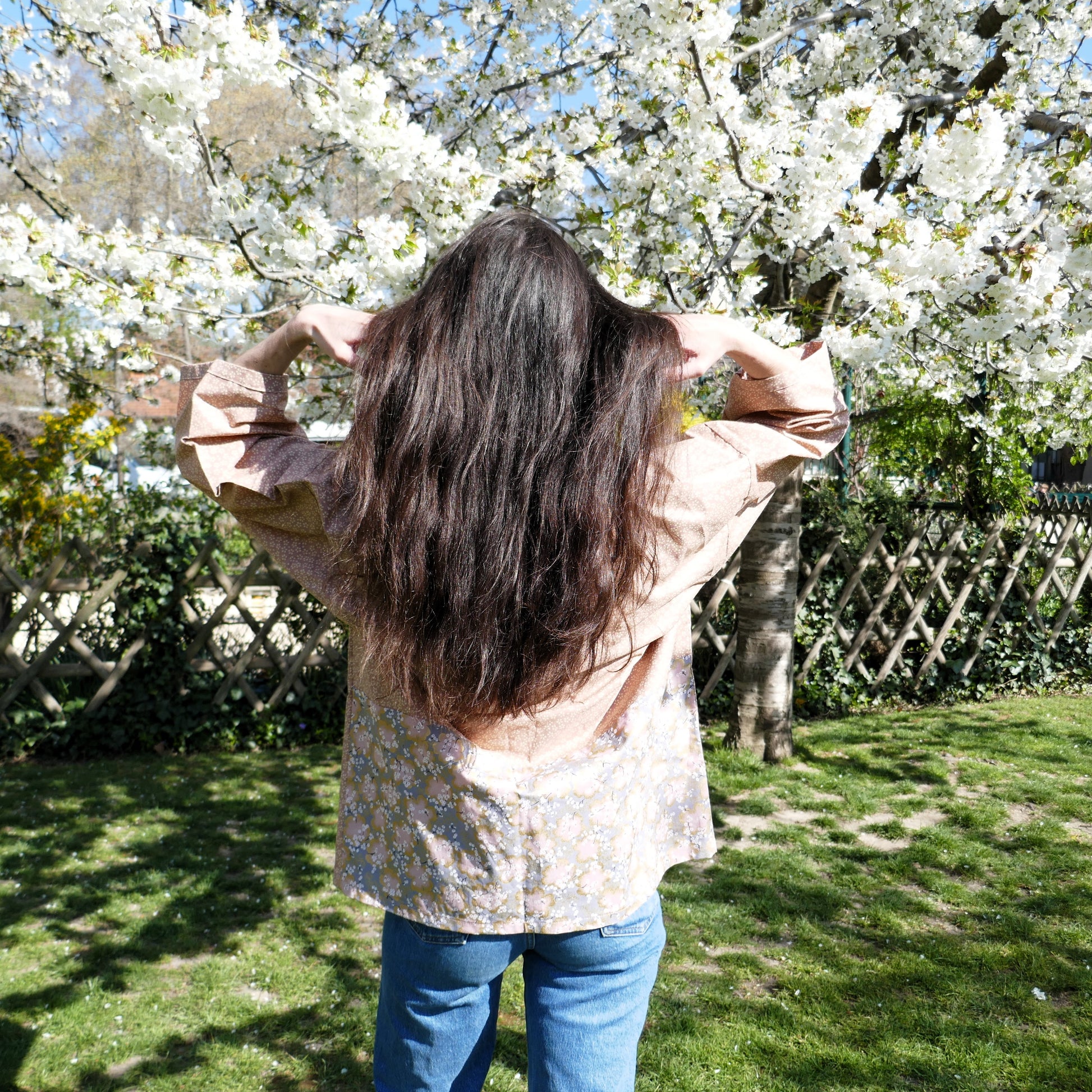 Vue de dos du haori Hanami by KOGEDO l'Atelier avec son empiècement floral, porté par Mayssa sous les cerisiers en fleurs – esprit hanami (花見) capturé.
