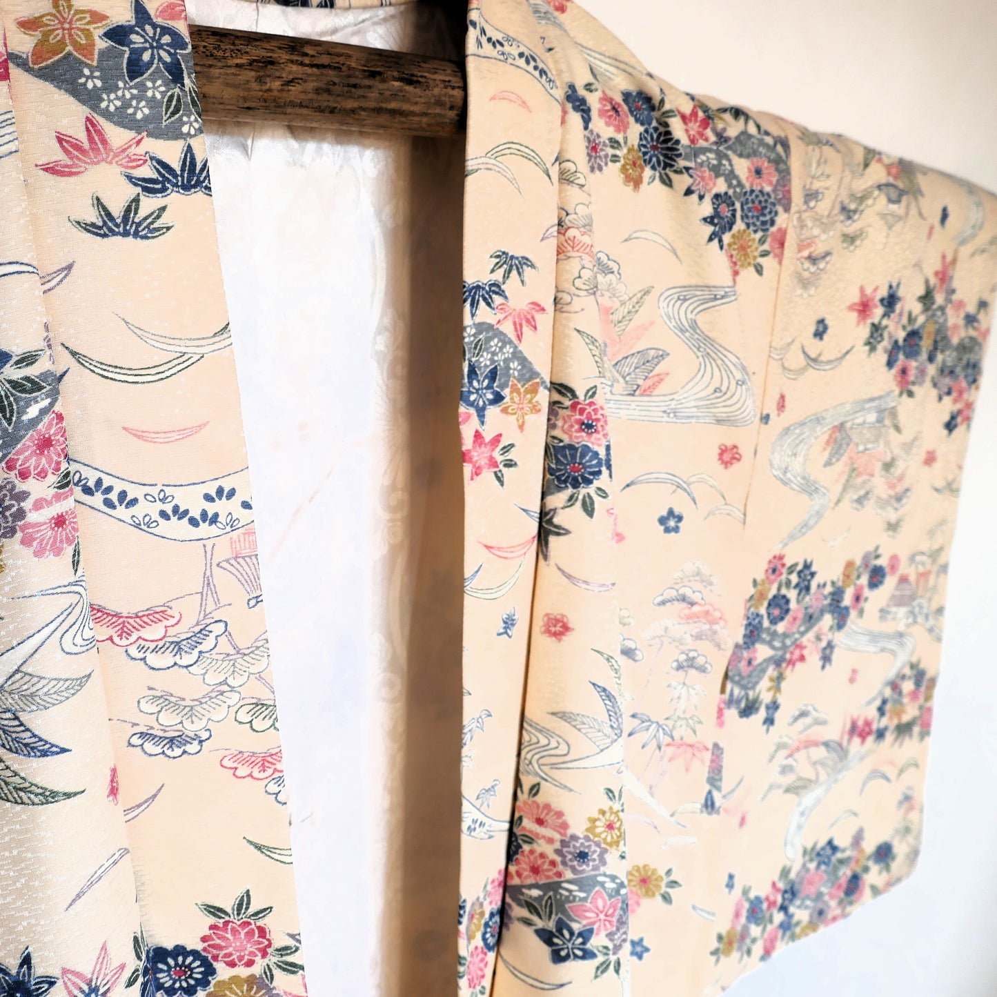 Vue rapprochée du devant d’un haori vintage japonais, col ouvert laissant apparaître la doublure à motifs végétaux