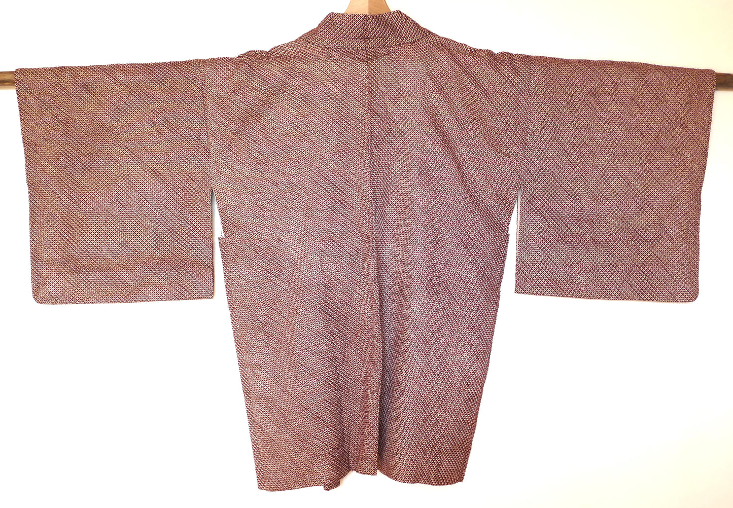 Vue arrière du haori japonais en soie bordeaux avec motif shibori géométrique.