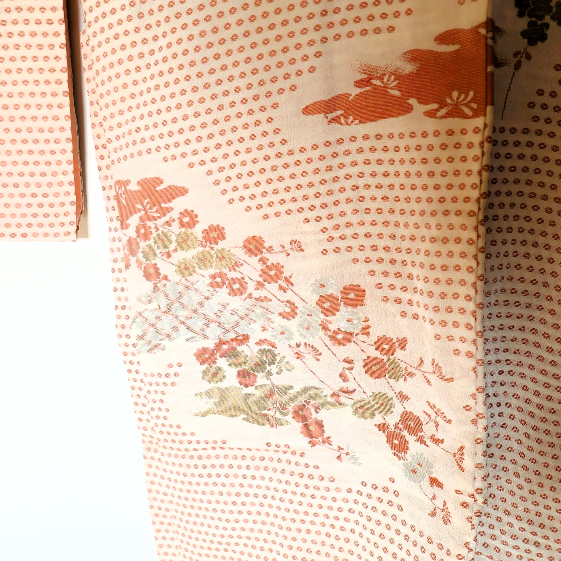 Zoom sur le motif floral raffiné du haori représentant fleurs de prunier et feuillage doré.