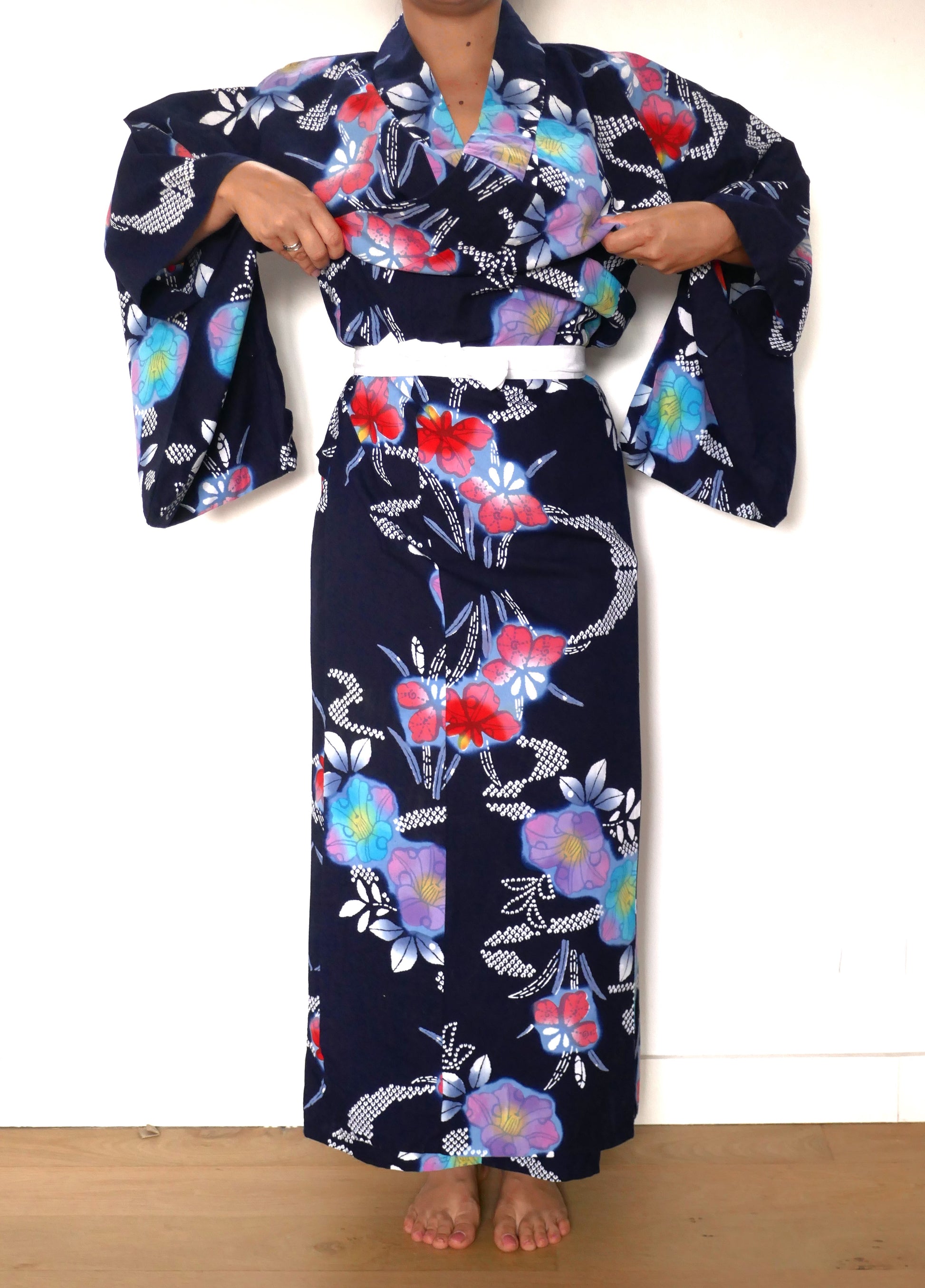 Yukata en coton bleu marine porté avec ceinture koshimo blanche, ajustement en cours.