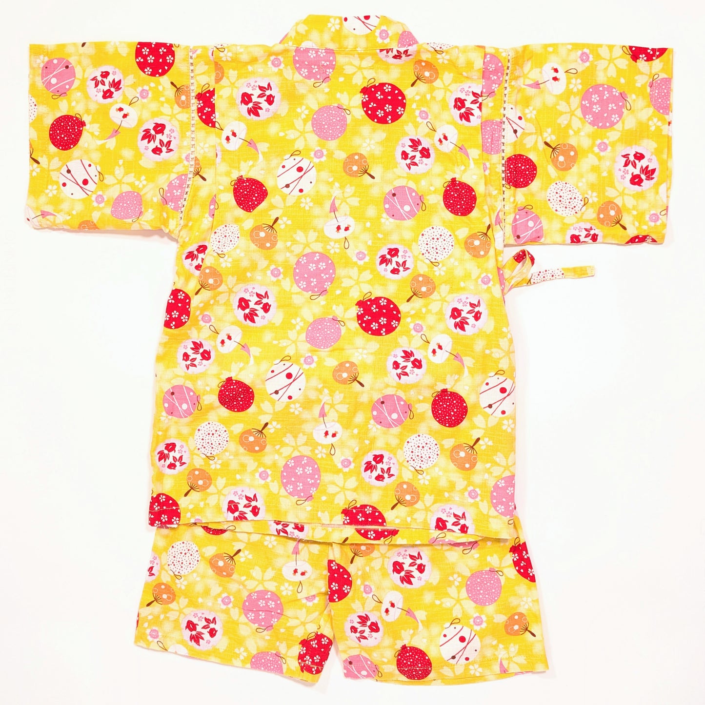 Ensemble jinbei enfant vu de dos, veste et short jaunes décorés de symboles de l’été japonais.