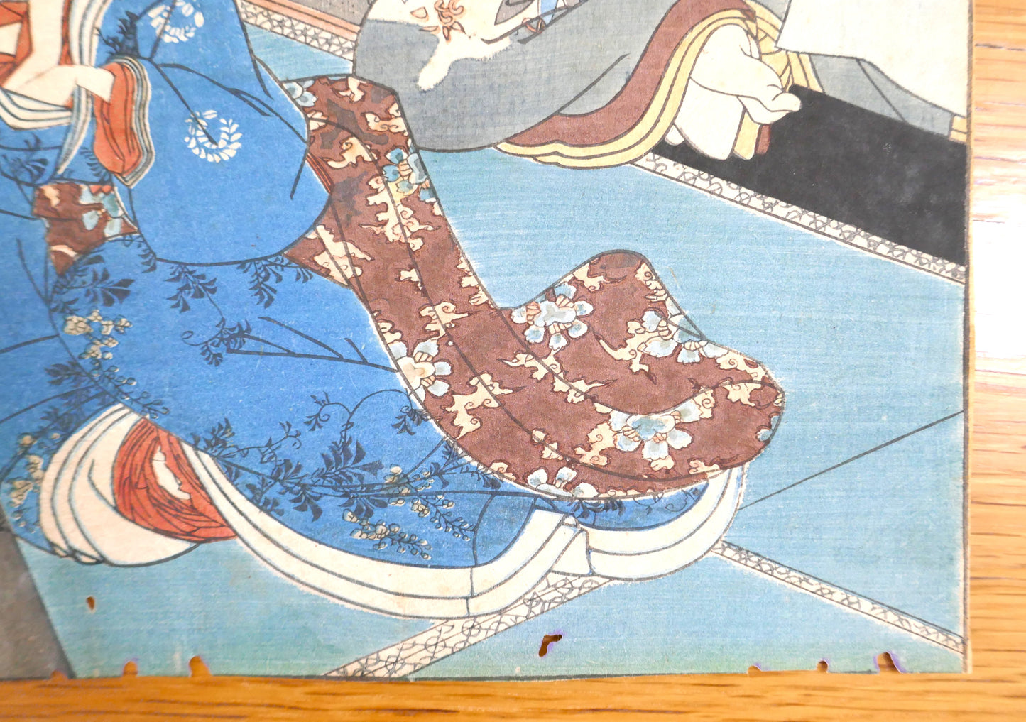 Détail du bas de l’estampe, motif fleuri du kimono et sol en tatamis.