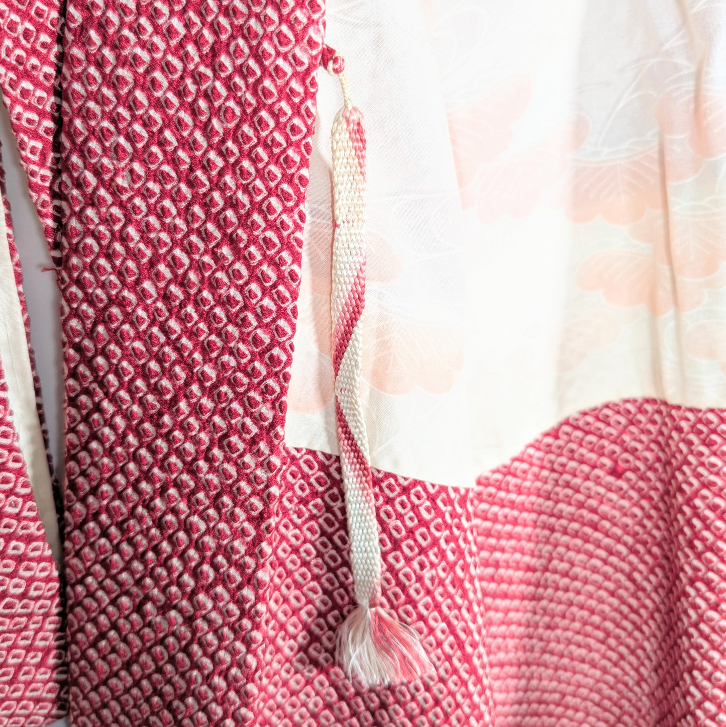 Haori himo traditionnel en soie attaché à une veste kimono shibori rouge, détail authentique du Japon