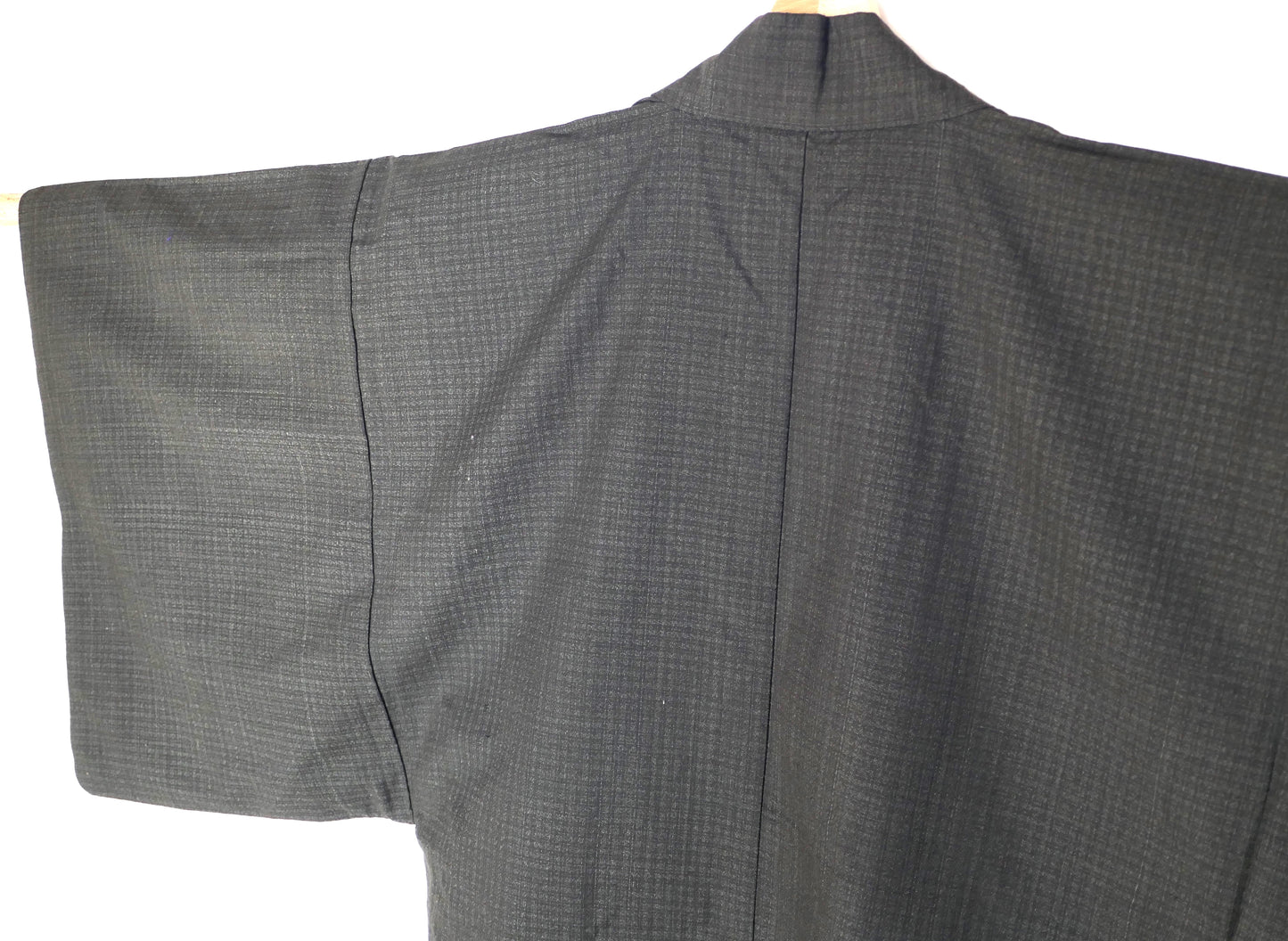 Détail du dos d’un haori japonais pour homme, tissage discret sur fond gris anthracite.