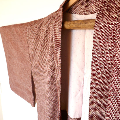 Zoom sur le col du haori shibori bordeaux en soie, doublure à motifs chrysanthèmes.