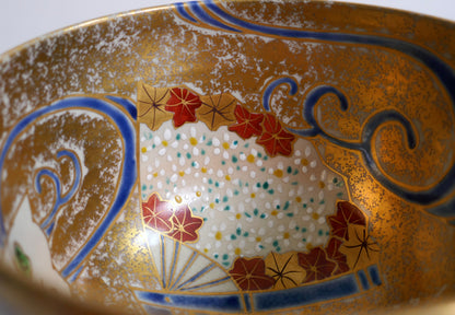 Détail intérieur du chawan avec éventail fleuri, feuilles d’érable momiji, motifs de vagues et fond doré en iro-e.