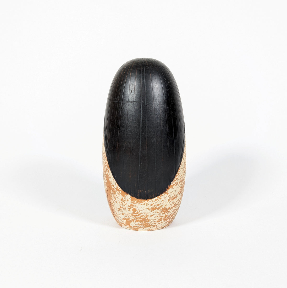 Dos de la kokeshi japonaise vintage Shôzan, avec sa longue chevelure noire sculptée et le décor blanc moucheté de son kimono.