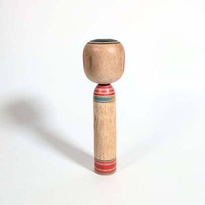 Arrière d’une kokeshi artisanale japonaise en bois tourné, style Tsuchiyu, objet d’art populaire du Japon époque Showa.