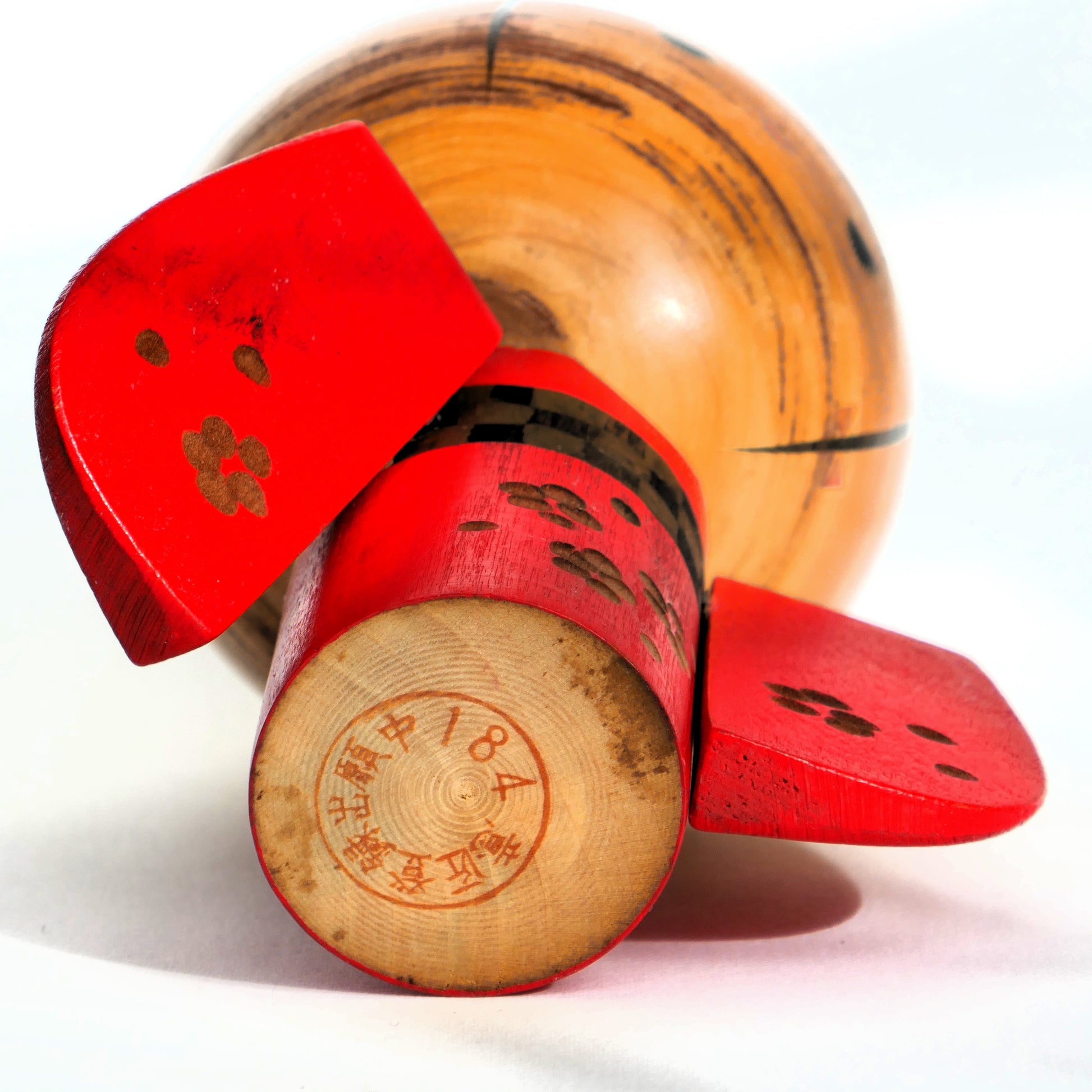Tampon sous la base de la kokeshi indiquant un dépôt de modèle numéro 184.