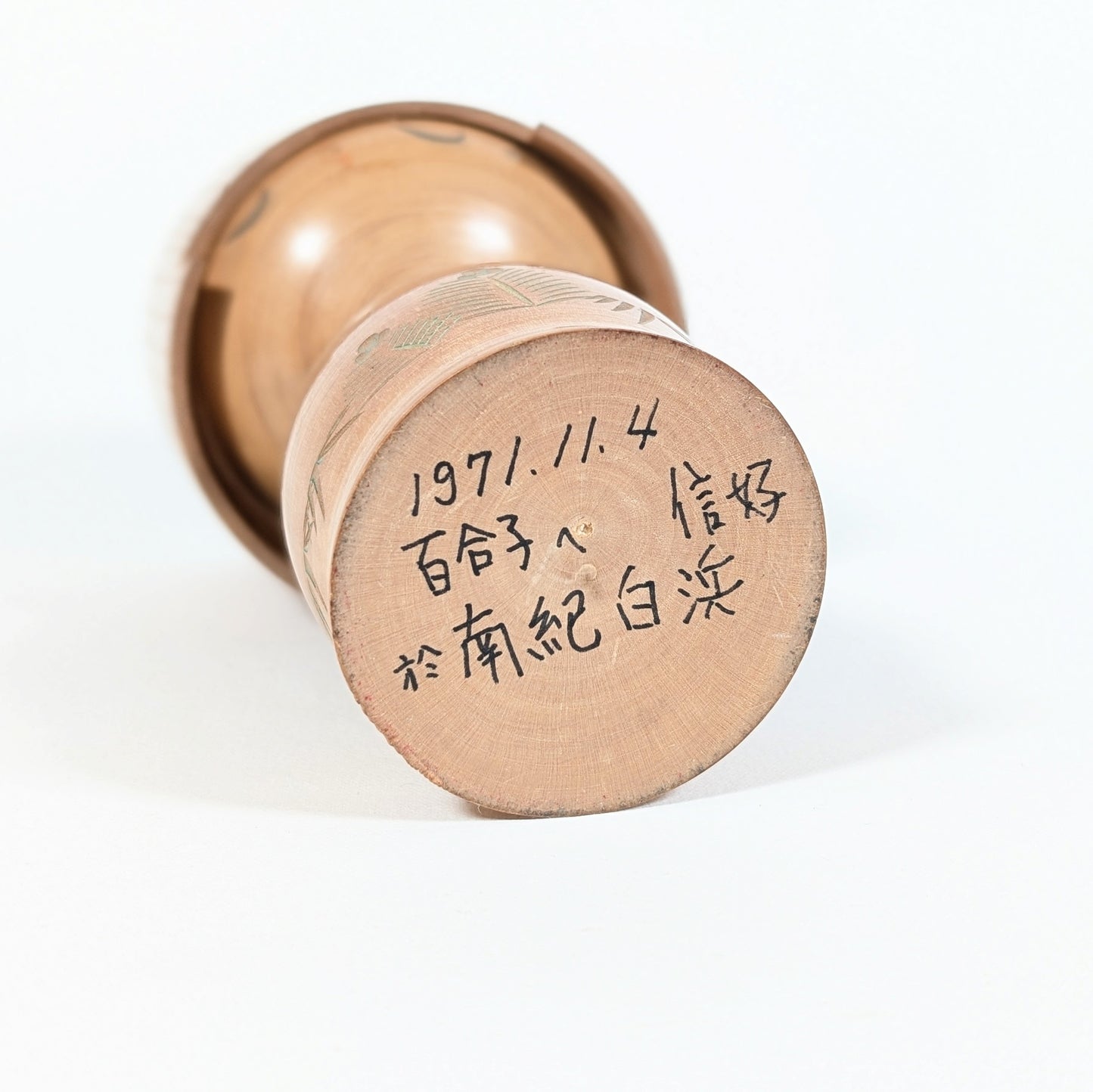 Dessous d’une kokeshi japonaise signée Hōshun par Ueda Izumi, inscription manuscrite datée 1971 sur socle en bois