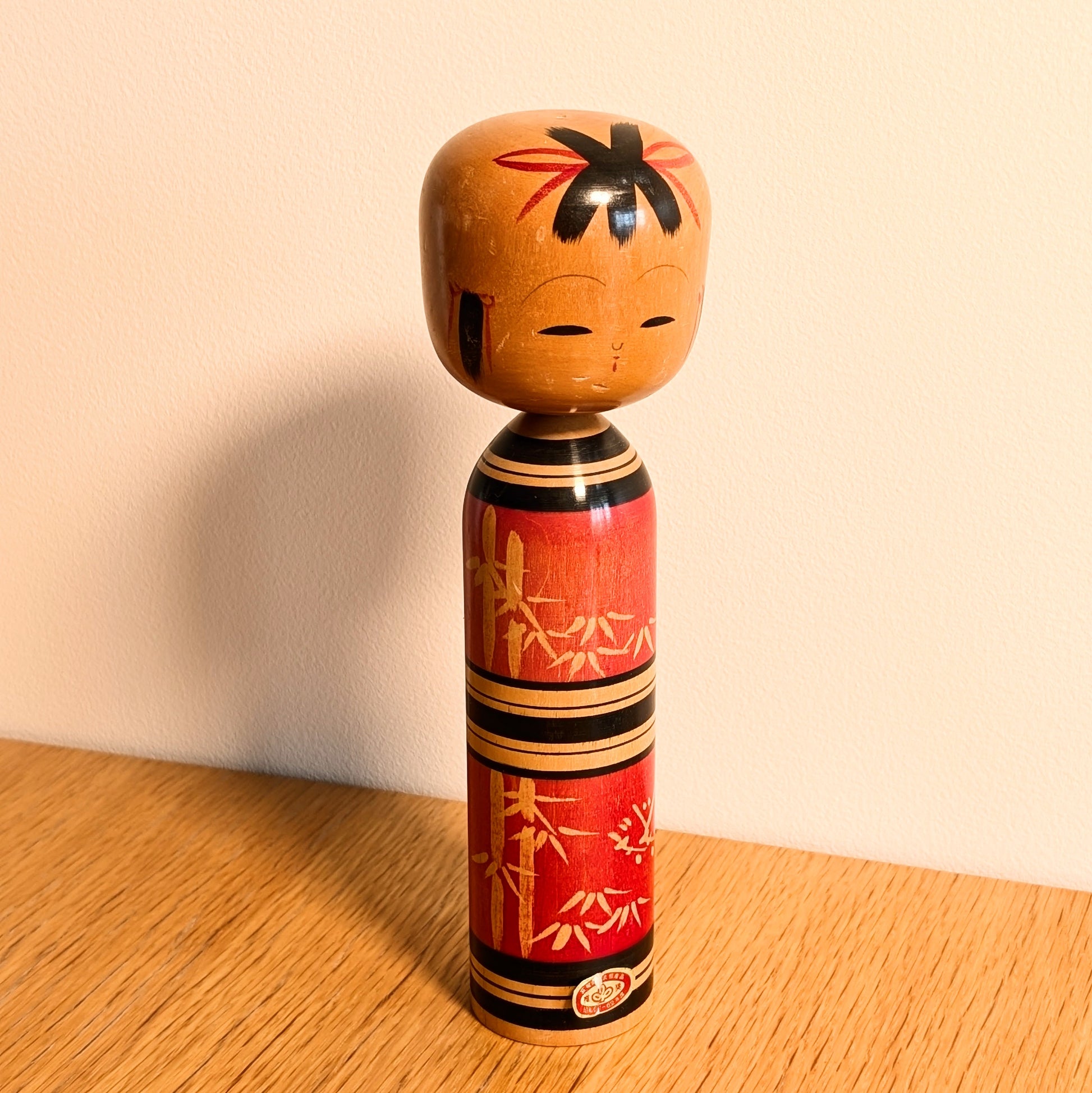 Kokeshi créative sosaku par Kawamura Shōji, poupée japonaise en bois rouge décorée de motifs de bambou