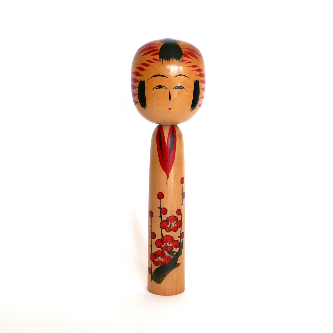 Kokeshi Togatta artisanale de Satō Kesakichi vue de face – poupée japonaise en bois avec fleurs de prunier rouges