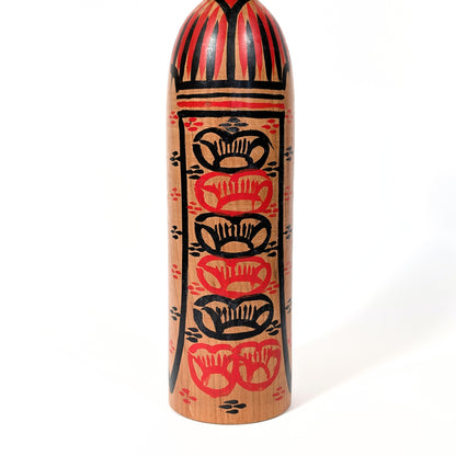 Motifs de fleurs de prunier ume sur une kokeshi poupée japonaise, décor floral stylisé traditionnel