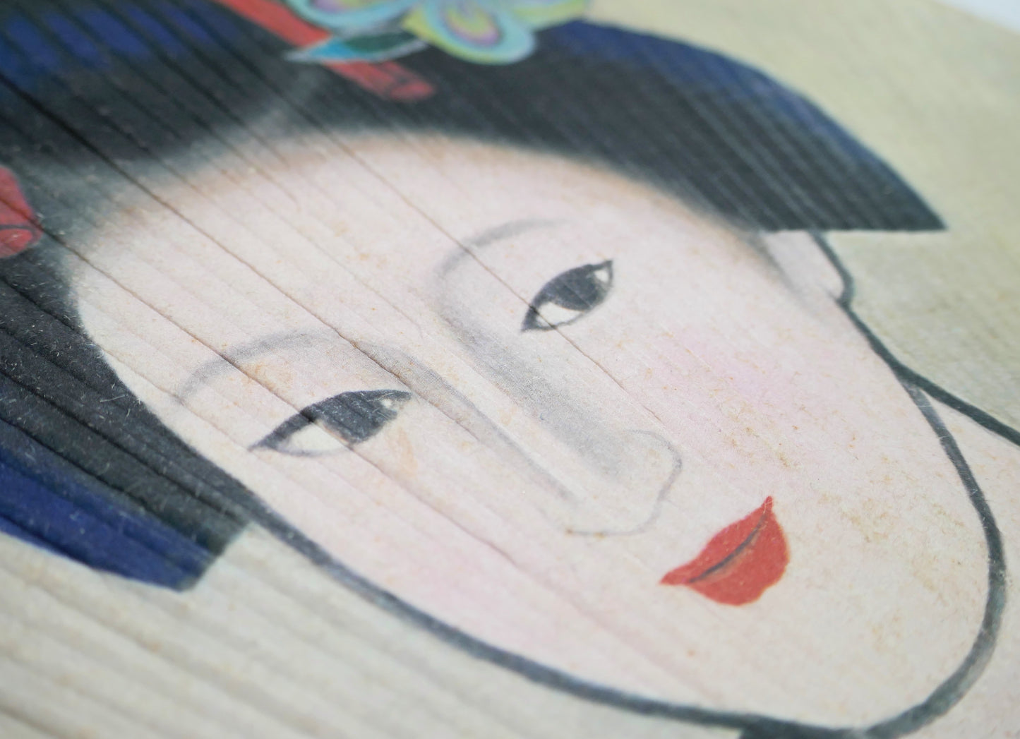 Détail du portrait bijin-ga sur éventail uchiwa japonais, femme en kimono avec coiffure traditionnelle et parure kanzashi