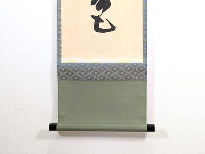Détail du bas d’un kakejiku japonais avec montage en soie verte et jikusaki noirs laqués, rouleau suspendu traditionnel