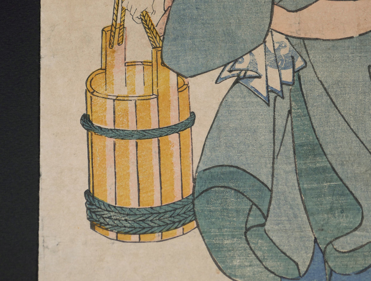 Détail des seaux en bois portés par Kichisuke, Rai Kunitoshi, dans cette estampe polychrome nishiki-e de Kuniyoshi liée à l’univers des forgerons japonais.