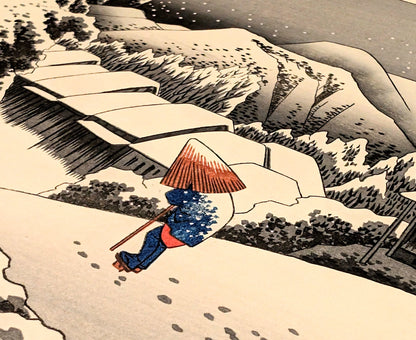 Voyageur japonais portant un manteau de paille et un chapeau kasa dans la neige, estampe Kanbara Hiroshige